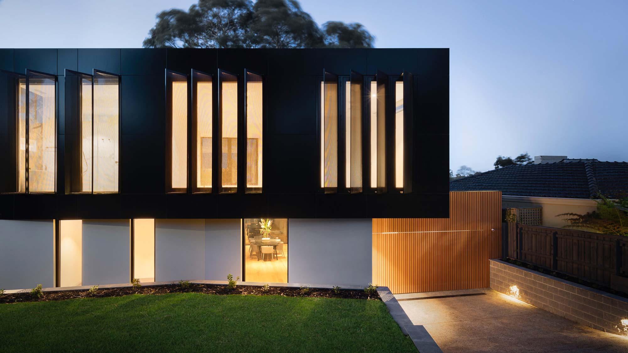 A contemporary home with sleek lighting highlighting its facade.
