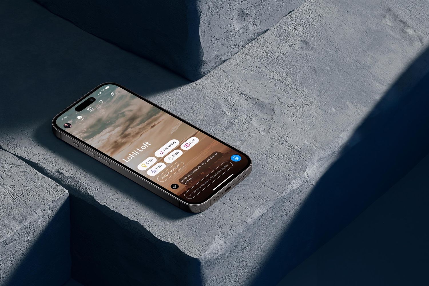 Smartphone resting on stone surface displaying a smart home control app interface