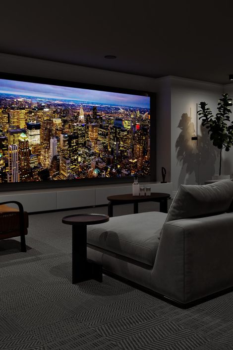 Modern home theater with a cityscape view displayed on a large screen and sleek seating.