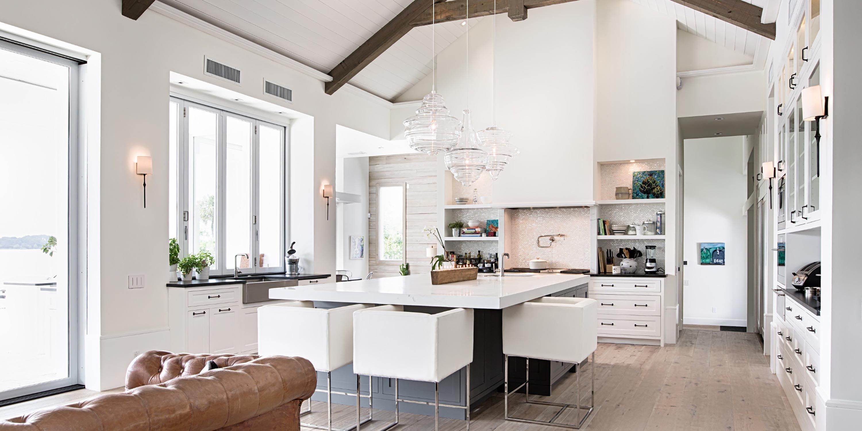 Bright, airy kitchen with vaulted ceilings, large island seating, and modern white cabinetry.