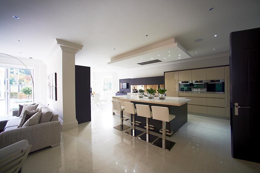 Spacious open-plan kitchen with a large island and stylish seating in a bright interior.