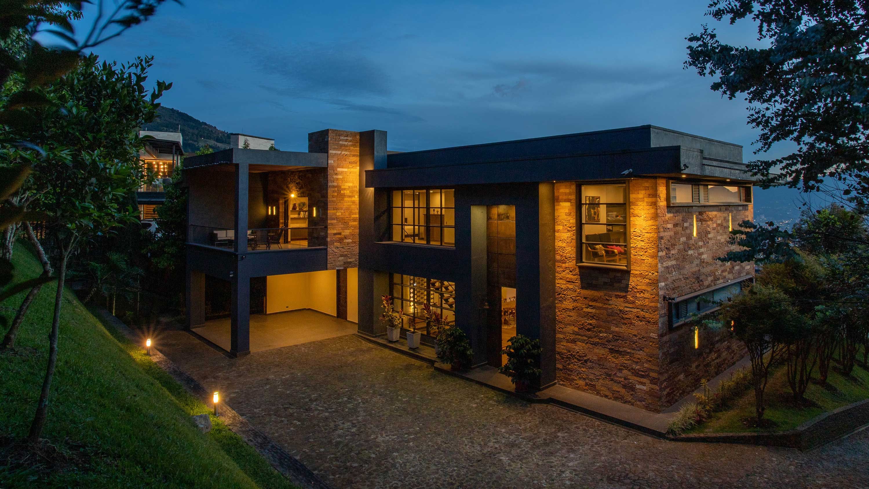 A house at dusk with warm outdoor lighting.